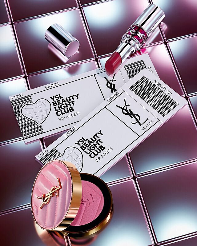 Make Me Blush, Loveshine lipstick, and two YSL Beauty Light Club VIP tickets on a reflective tiled background.