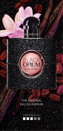 A sleek black bottle of Yves Saint Laurent's Black Opium Eau de Parfum sits against a backdrop of pink flowers and coffee beans, emphasizing its enticing and glamorous design.