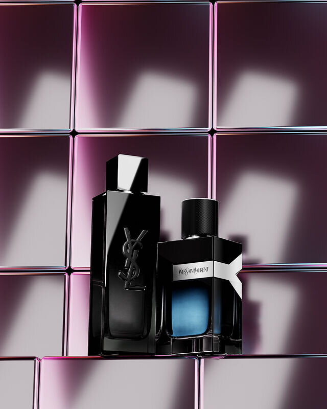 YSL Y and Y Le Parfum men's fragrances on a reflective surface with a purple tiled background.