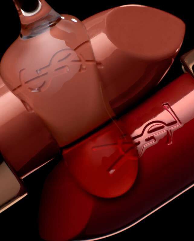 A close-up image of two YSL lipstick tubes, one nude and one deep red, positioned partially overlapping against a dark background.