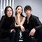 A group of three stylish models poses together in a minimalist setting. They convey a sense of confidence and fashion, with the logo "YSL BEAUTY CLUB" featured prominently at the bottom.