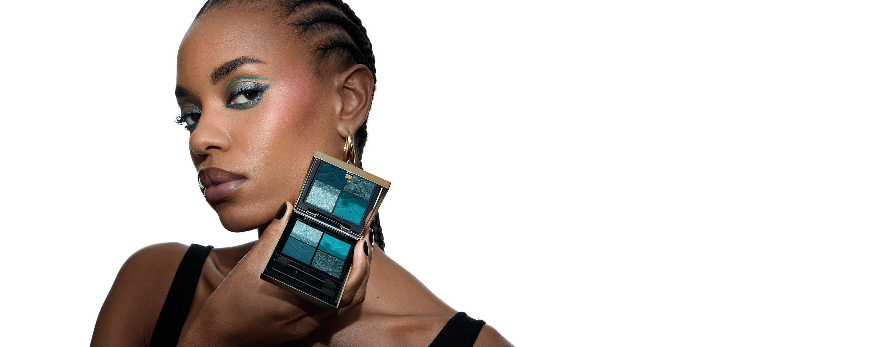 Lizette, ein Model von YSL Beauty, hält eine YSL Couture Mini Clutch Lidschattenpalette mit passendem türkisfarbenem Augen-Make-up.